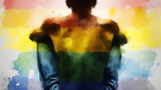 Illustration av en man som sitter på marken med regnbågsfärger. Foto: Mostphotos