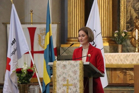 Bild på Lydia Eklund som håller de nyutexaminerade sjuksköterskornas tal.