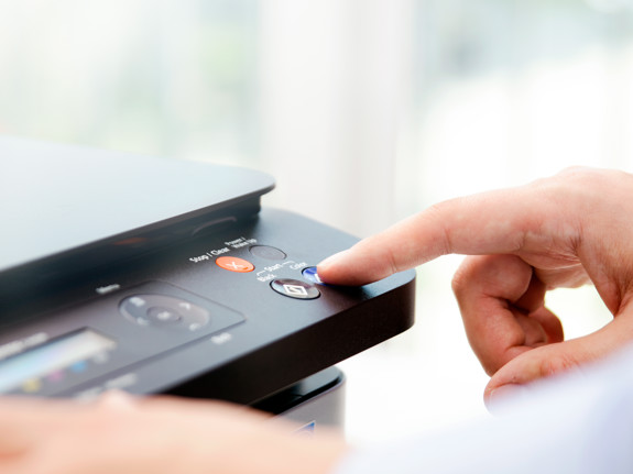 Personer som använder en skrivare. Foto: Mostphotos.