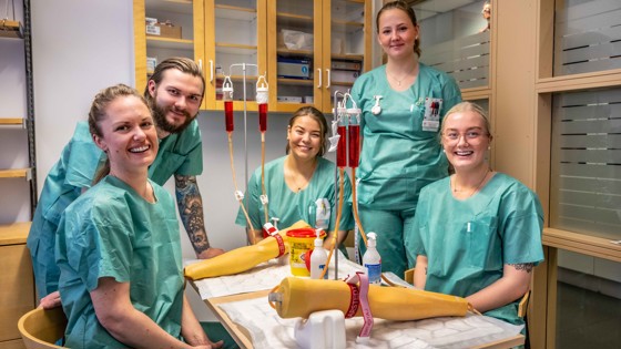 Fem sjuksköterskestudenter som övar på att ta blodprov. Foto: Jenny Frejing