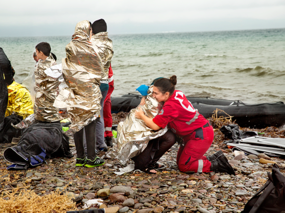 Flyktingar som mottas vid en strand av Röda Korset frivillig. Foto:SRK