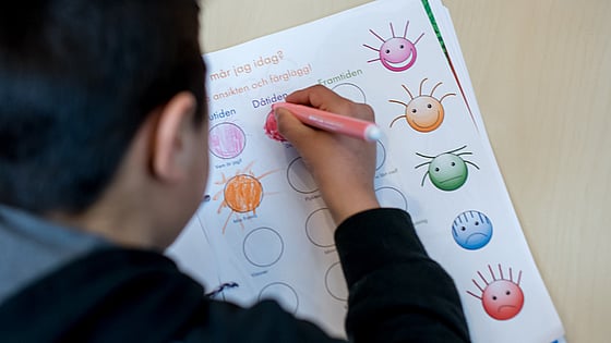 Barn som skriver med en penna. Foto:SRK