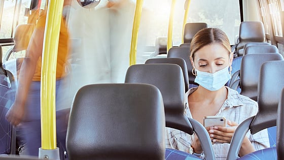Kvinna med munskydd på en buss. Foto:Mostphotos