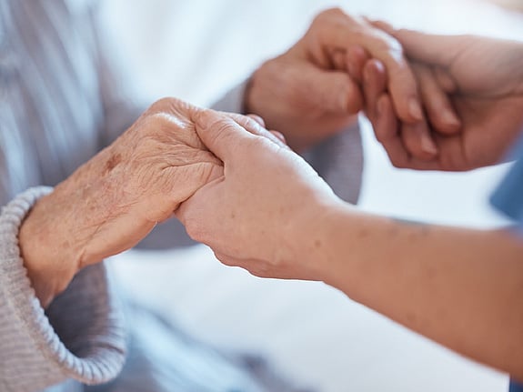 Två personer som håller varandras händer. Foto: Mostphotos.
