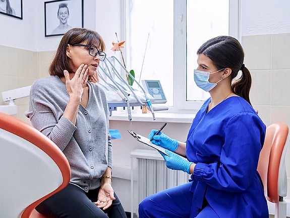 Patient i samtal med tandläkare. Foto: Mostphotos.